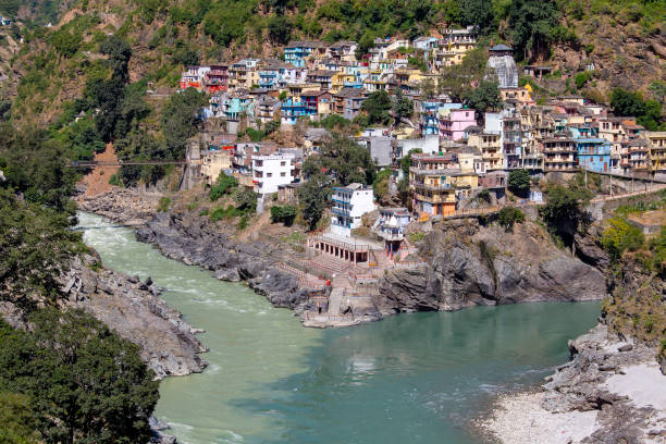 Devprayag is the last prayag of Alaknanda River and from this point the confluence of Alaknanda and Bhagirathi River is known as Ganga. Uttarakhand, India DEVPRAYAG, INDIA - OCTOBER 13, 2014 : Devprayag of Uttarakhand, is one of Panch Prayag, five confluences, of Alaknanda River where Alaknanda and Bhagirathi rivers meet and take the name Ganges River prayagraj photos stock pictures, royalty-free photos & images