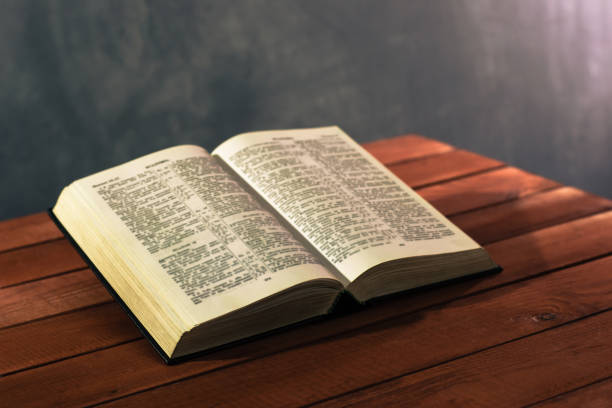 istock Bible on a red wooden table. Beautiful background.Religion concept 1051056068