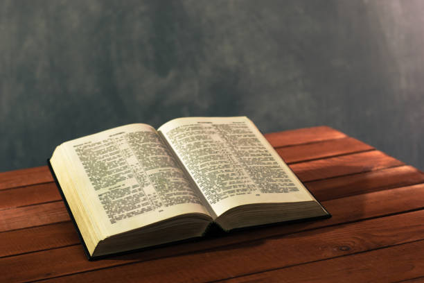 istock Bible on a red wooden table. Beautiful background.Religion concept 1051061044