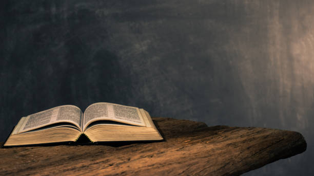 istock Bible on a old oak wooden table. Beautiful dark background.Religion concept 1051064992
