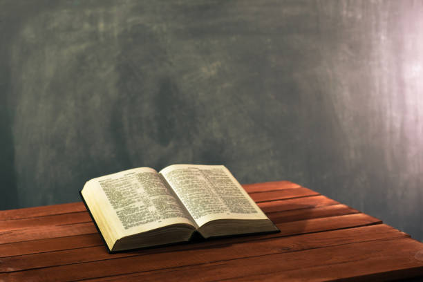 istock Bible on a red wooden table. Beautiful background.Religion concept 1051065728