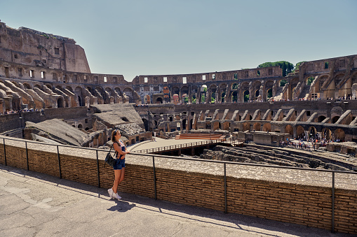 Italian vacations series. Young woman tourist in Rome over Colosseum
