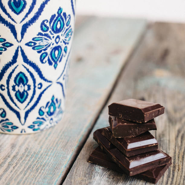 Cup of coffee and chocolate on a wooden table