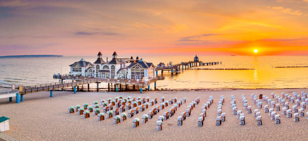 Sellin Pier at sunrise, Baltic Sea, Germany Famous Sellin Seebruecke (Sellin Pier) in beautiful golden morning light at sunrise in summer, Ostseebad Sellin tourist resort, Baltic Sea region, Germany rügen stock pictures, royalty-free photos & images