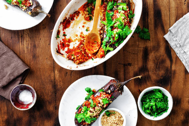 Stuffed eggplants wooden table top view Vegetarian healthy dinner