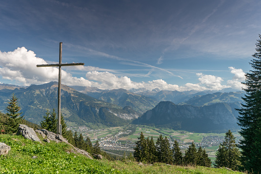 mountain landscape in the Swiss Alps with a summit cross