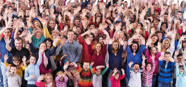 istock Large group of happy people waving and looking at camera. 1051085006