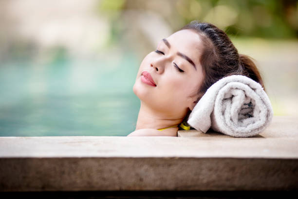 istock Pretty asian woman lying on the poolside 1051085486