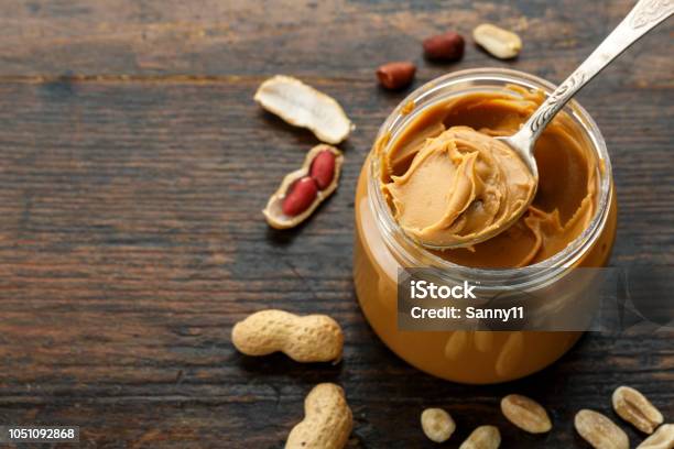 Peanut Paste In An Open Jar And Peanuts Stock Photo - Download Image Now - Peanut Butter, Butter, Peanut - Food