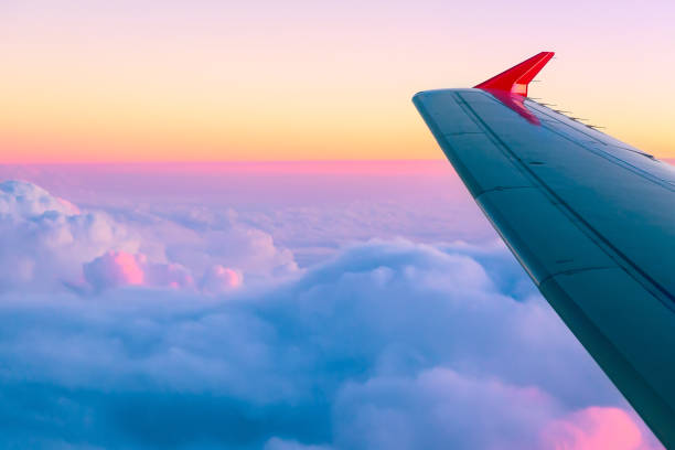 istock Beautiful sunset sky above clouds with nice dramatic light. View from airplane window 1051095892