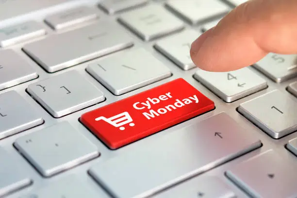 Photo of Cyber Monday on key board. shopping enter button key on keyboard. Color button on the gray silver keyboard of modern ultrabook. caption on the button