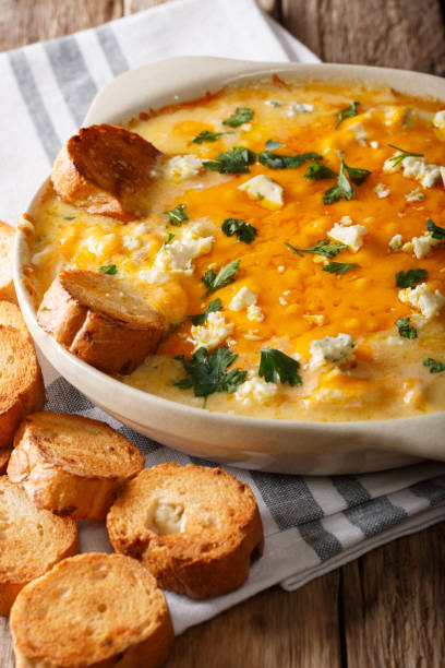 istock Delicious buffalo chicken dip and crostini macro in a dish. vertical 1051096126