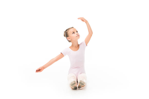 adorable little ballerina practicing isolated on white background