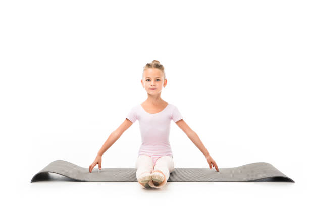 istock child practicing gymnastics exercises on fitness mat isolated on white background 1051098472