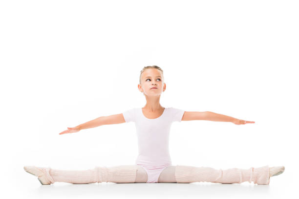istock little child exercising and doing twine isolated on white background 1051098496