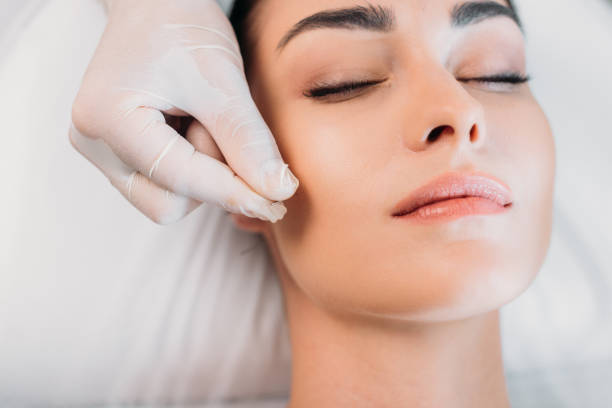 istock partial view of cosmetologist putting needle on womans face during acupuncture therapy in spa salon 1051100486