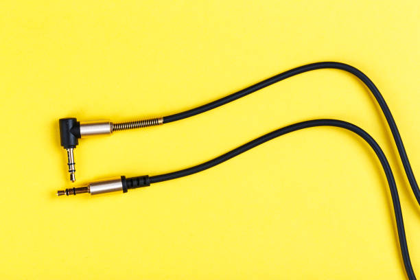istock cable to a mobile phone on a yellow background. 1051110086