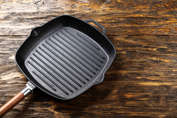 istock empty clean grill pan on a shabby wooden surface. 1051110908