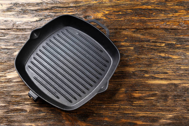 istock empty clean grill pan on a shabby wooden surface. 1051111288