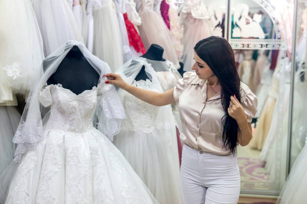 istock Beautiful brunette bride choosing dress for wedding 1051111540