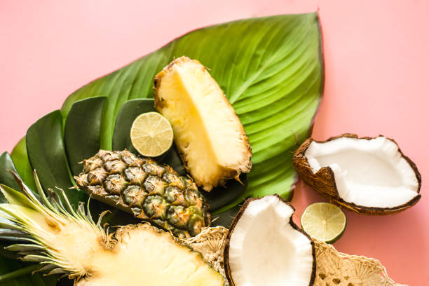 istock tropical fruits with leaves on a pink background 1051115462