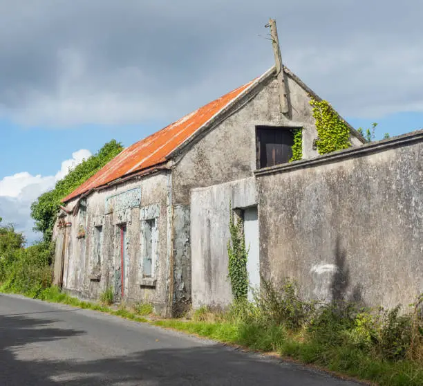 Photo of The abandoned Hannon's Stores building next to a country road near Headford, in County Galway, Ireland.