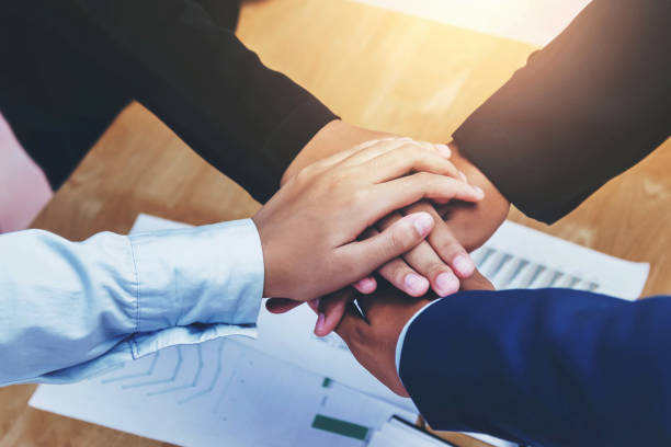 istock closeup business teamwork join hand in office 1051123604