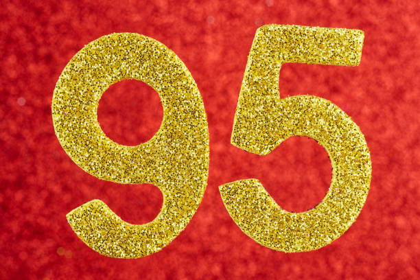 istock Number ninety-five golden color over a red background. Anniversary 1051123934