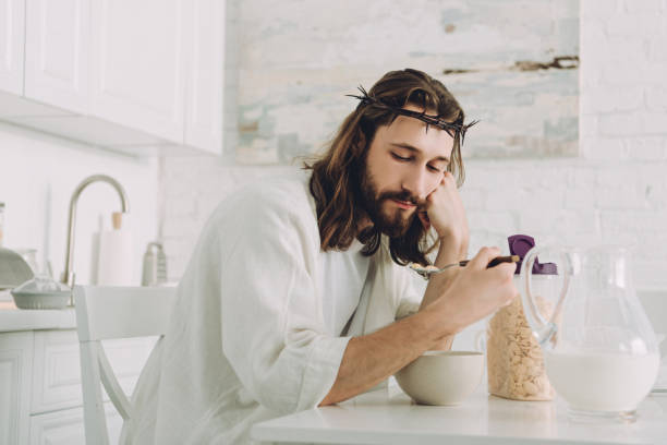 istock tired Jesus eating corn flakes on breakfast in kitchen at home 1051127228