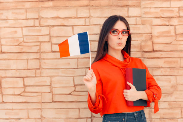Student Holding Flag and Book Learning Foreign Language Multilingual polyglot girl learning new words from a  dictionary french language photos stock pictures, royalty-free photos & images