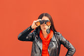 Visionary Millennial Girl Looking through Binoculars