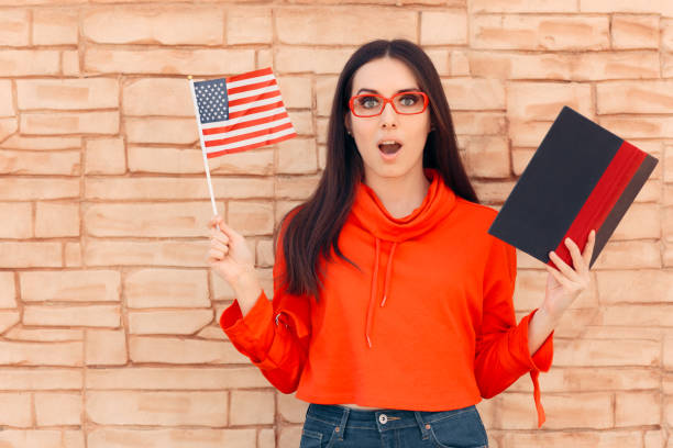 Student Holding Flag and Book Learning Foreign Language Multilingual polyglot girl learning new words from a  dictionary Study Abroad Countries stock pictures, royalty-free photos & images