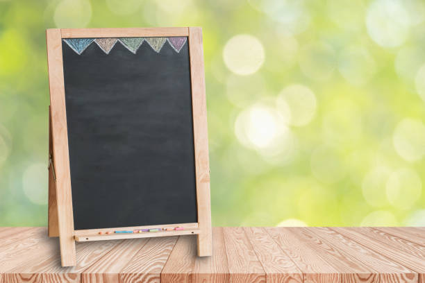 istock Wood table top on blur green background. 1051132326