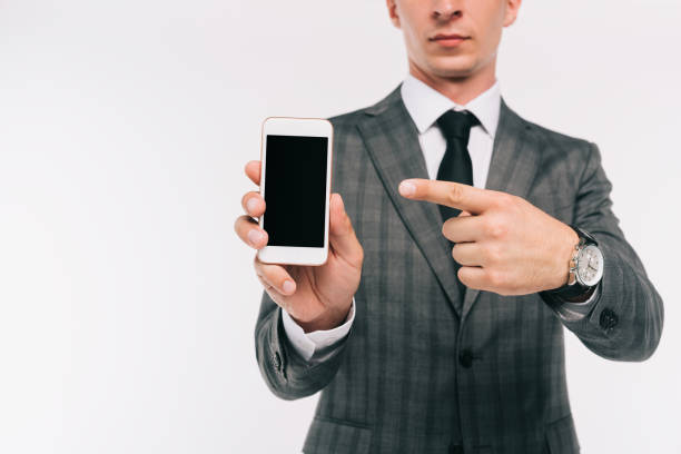 istock cropped image of businessman pointing on smartphone with blank screen isolated on white 1051136338