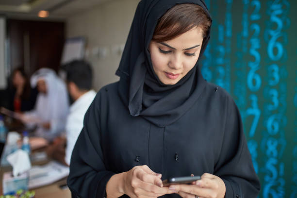 istock Businesswoman using mobile phone in board room 1051136756