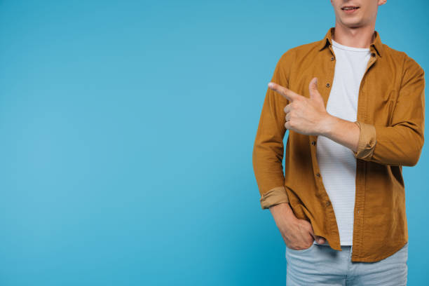 istock cropped image of man pointing on something isolated on blue 1051139278