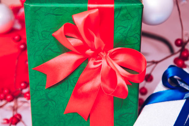 istock Green gift box with red ribbon. 1051143242