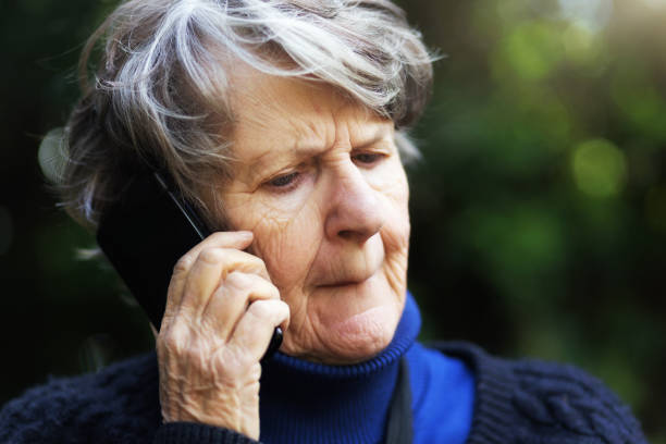 istock Senior woman using phone looks anxious, biting lip 1051144792