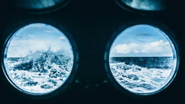From the porthole window of a vessel in a rough sea