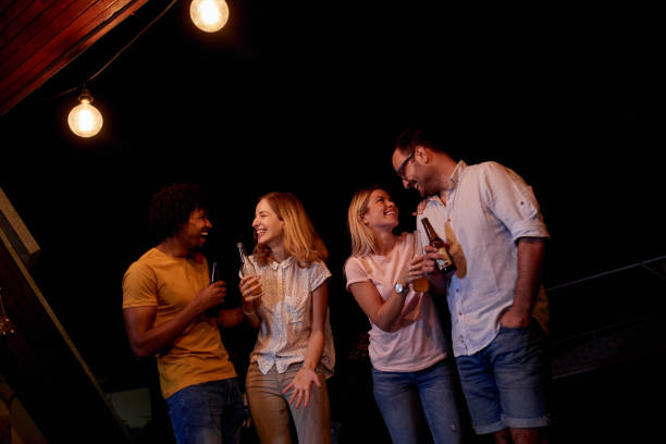 istock Joyful friends having a drinking party during the night on a terrace. 1051148728
