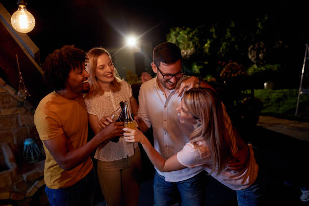 istock Joyful friends having a drinking party during the night on a terrace. 1051151090