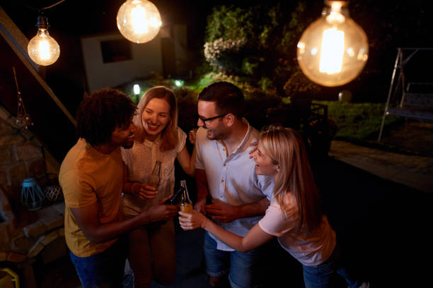 istock Joyful friends having a drinking party during the night on a terrace. 1051151286