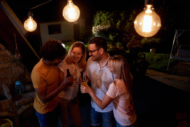 istock Joyful friends having a drinking party during the night on a terrace. 1051151384