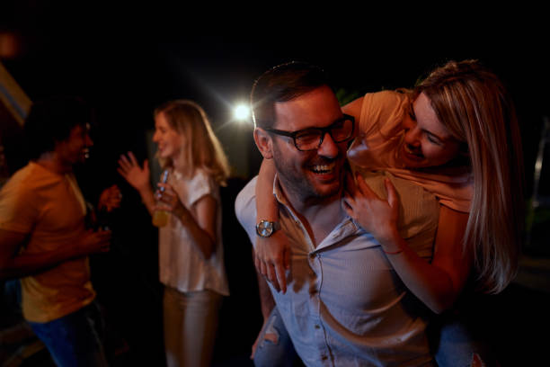 istock Joyful friends having a drinking party during the night on a terrace. 1051151580