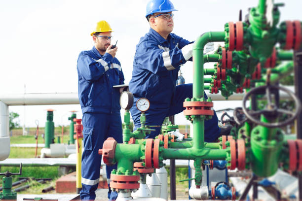 istock Two petrochemical workers inspecting pressure valves on a fuel tank 1051155988