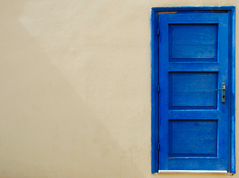 blue seperated door at a wall in Sissi on Crete in Greece