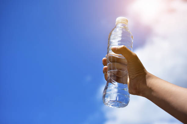 istock Hand holding drinking water for drink after exercise body sport 1051160866