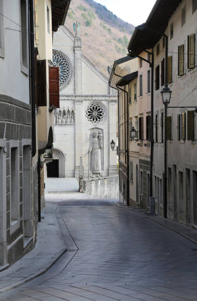 Cathedral of Gemona a city in the Northern Italy facade of Cathedral of Gemona a city in the Northern Italy and the narrow street gemona del friuli stock pictures, royalty-free photos & images