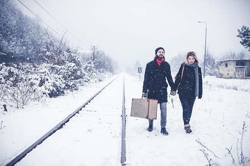 Couple walking on railroad