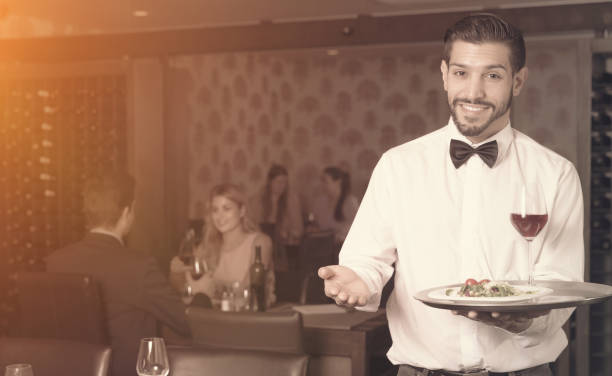 istock waiter with serving tray meeting guests 1051171650